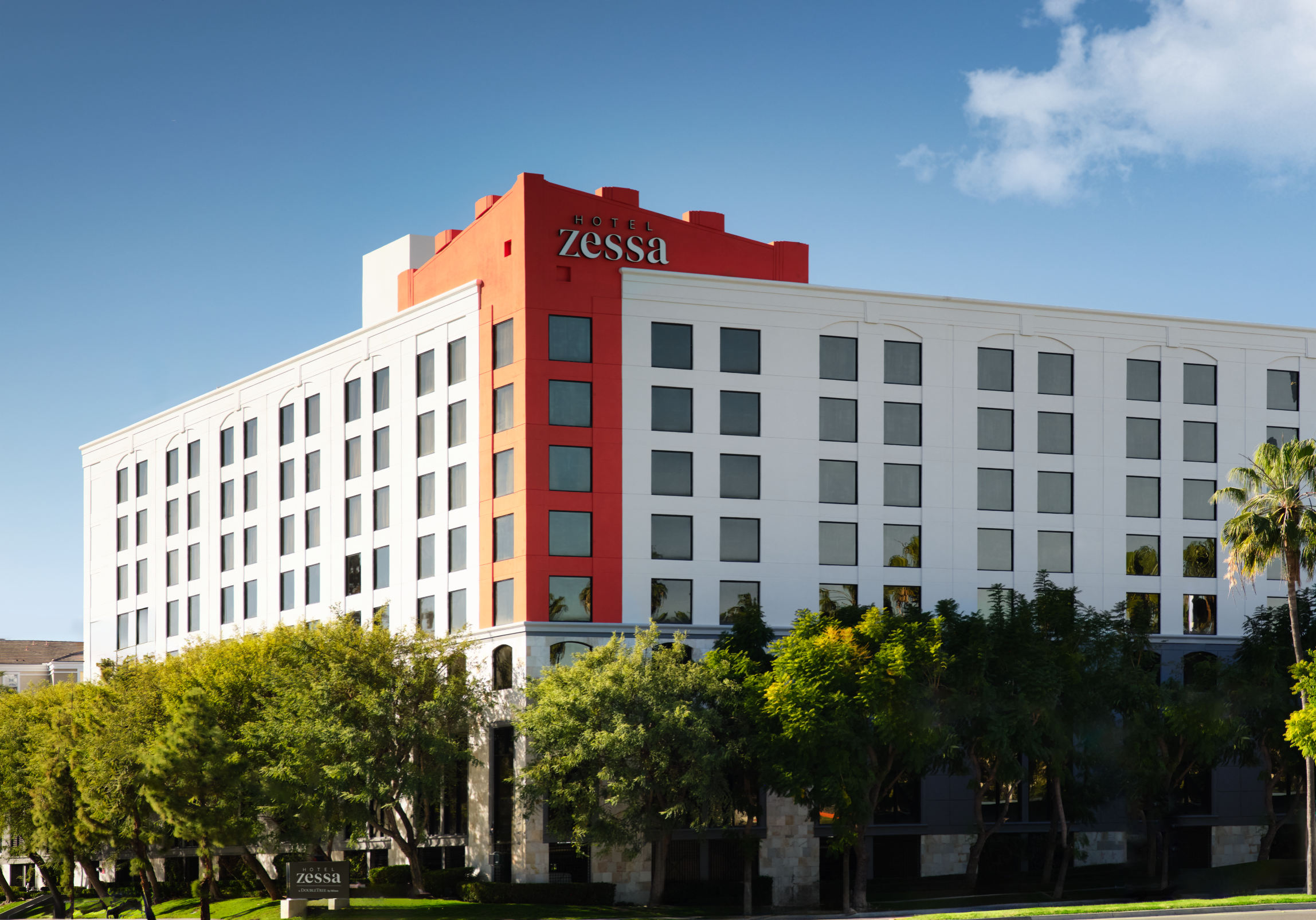 exterior of hotel with trees and sky